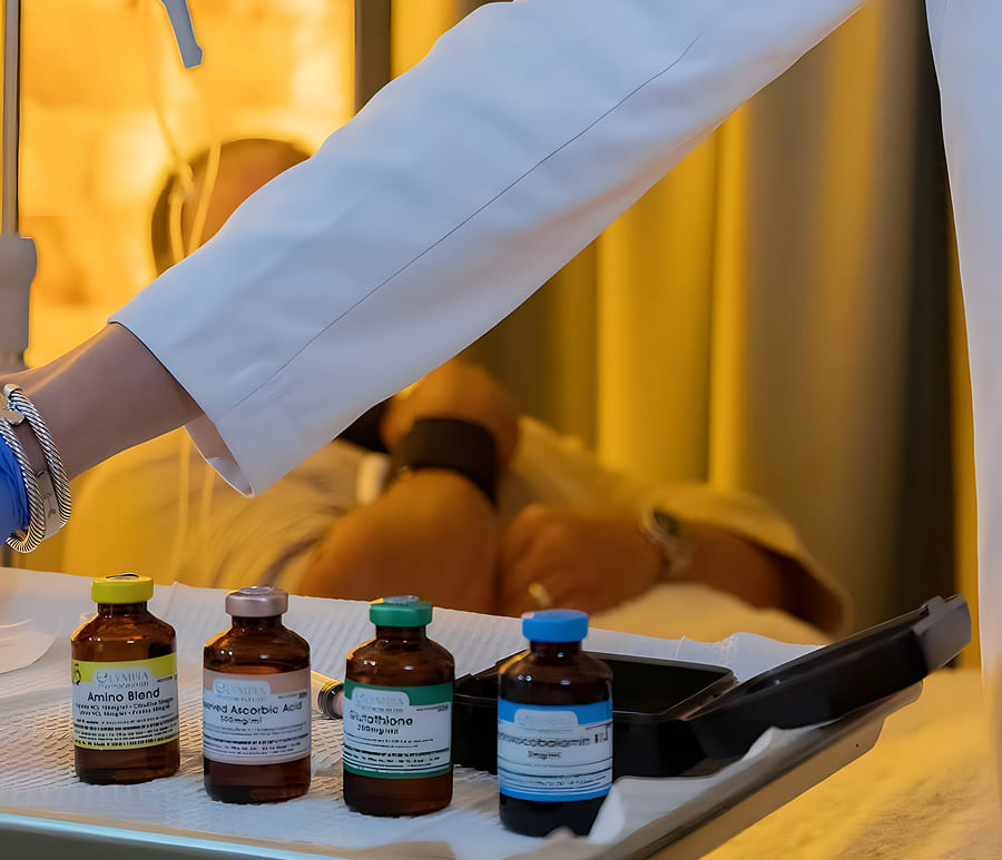 Medical professional preparing IV drip near supplement bottles, highlighting hydration, energy, and wellness benefits.