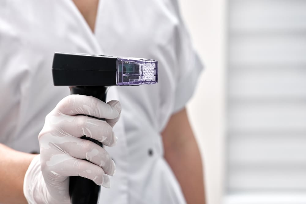 Medical professional holding device representing post-Botox care and signs to contact provider during recovery