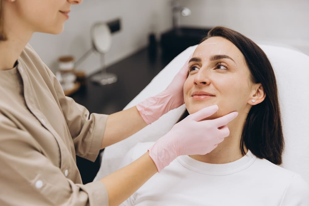 Patient consulting with practitioner about Dysport or Botox treatment options for facial aesthetic results